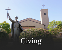 A statue of St. Isaac Jogues beside bushes